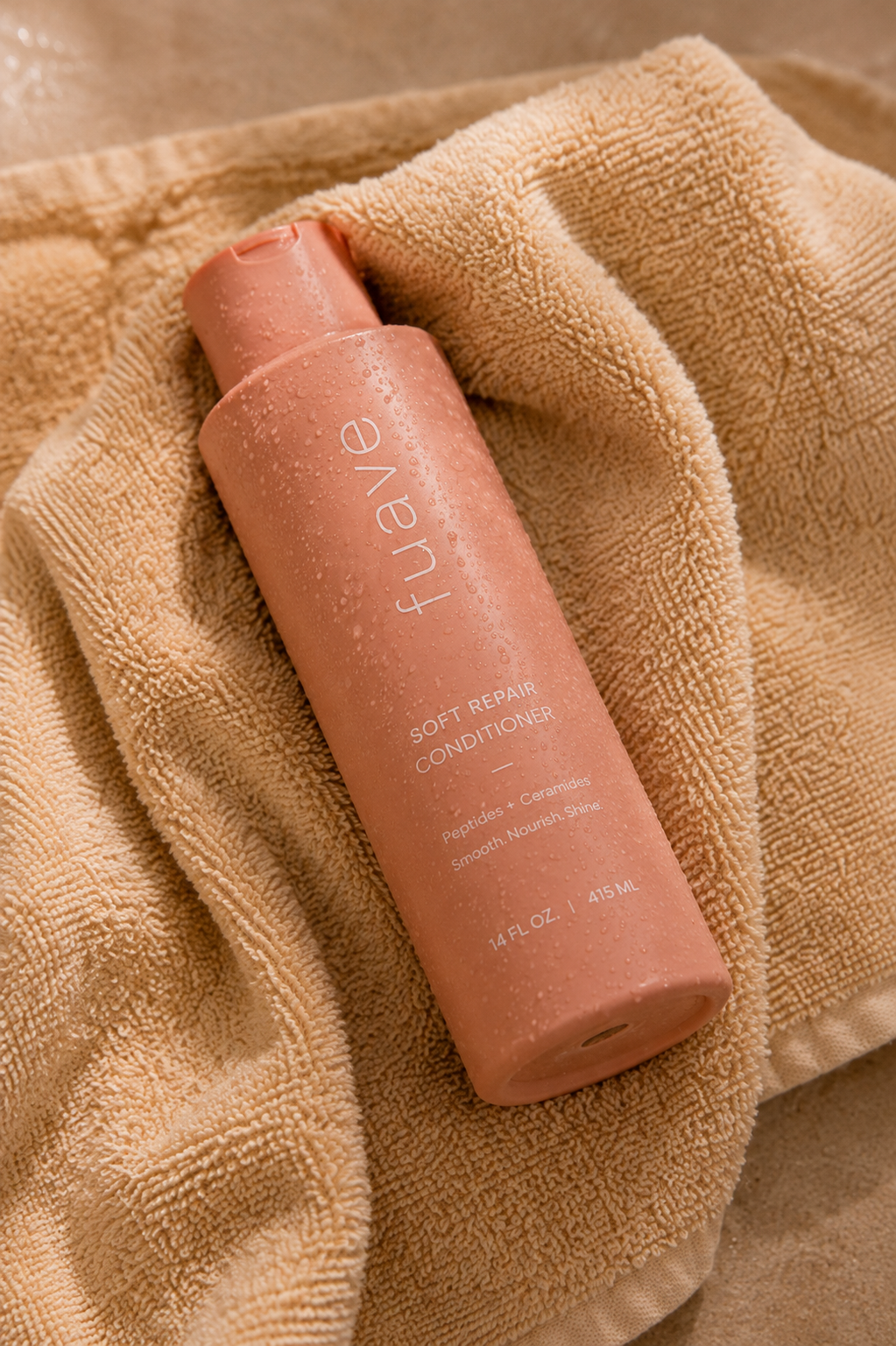 FUAVE Soft Repair Conditioner resting on a soft beige towel